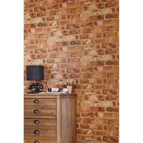 A Wooden Dresser Sitting Next To A Brick Wall With A Lamp On Top Of It