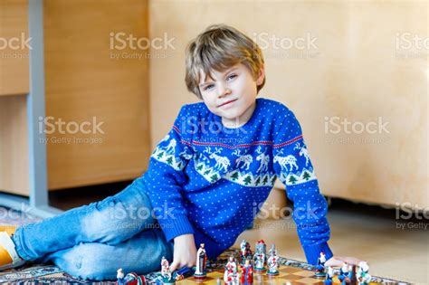 Little Preschool Kid Boy Playing Chess Game At Home Stock Photo