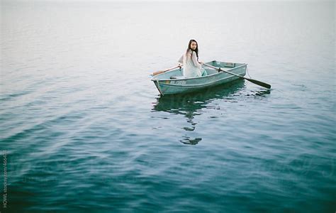 Lonely Girl Floats Alone In A Row Boat On A Foggy New England Morning