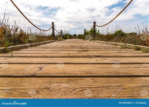 Wooden Boardwalk In The Dunes Leading To The Sandy Beach The Pa Stock