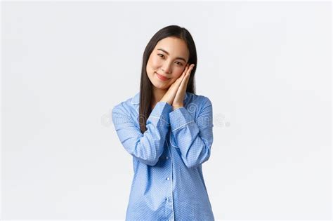 Smiling Beautiful Asian Woman In Blue Pajamas Going To Sleep Looking