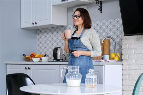 Home Portrait Of Mature Woman Housewife In Apron In Kitchen Stock Image Image Of Female Adult