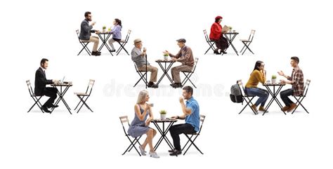 Young And Elderly People Sitting On Tables In A Cafe Stock Image