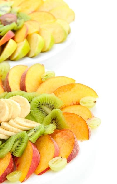 Premium Photo Assortment Of Sliced Fruits On Plates Isolated On White