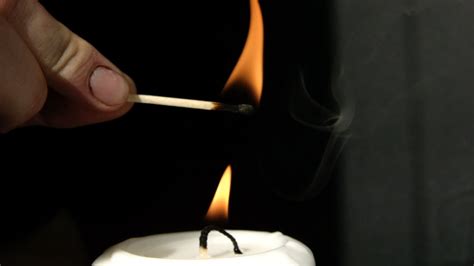 Slow Motion Video Of A Candle Being Relit By Lighting Its Smoke After