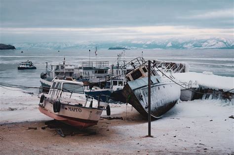 Rusty Boats Abandoned On Snowy Beach · Free Stock Photo