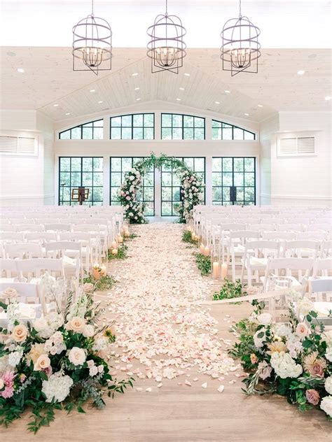 The Aisle Is Decorated With Flowers And Candles