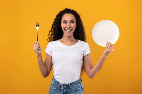 Portrait Of Smiling Latin Lady Holding Fork And Plate Stock Image