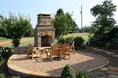 Large pebble stones are placed along the side of the pond with a few green shrubs for some color. Pebble Patio with Flagstone Outline and Outdoor Fireplace ...