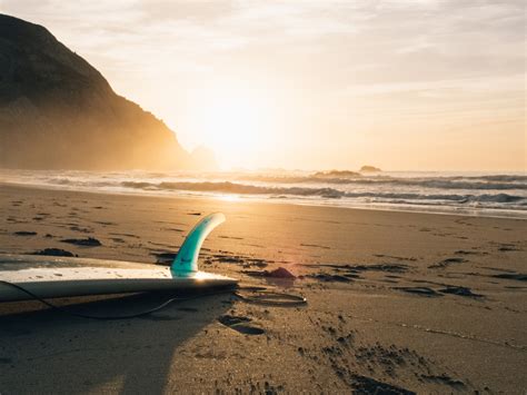 Surfboard On The Beach By Joschko Hammermann