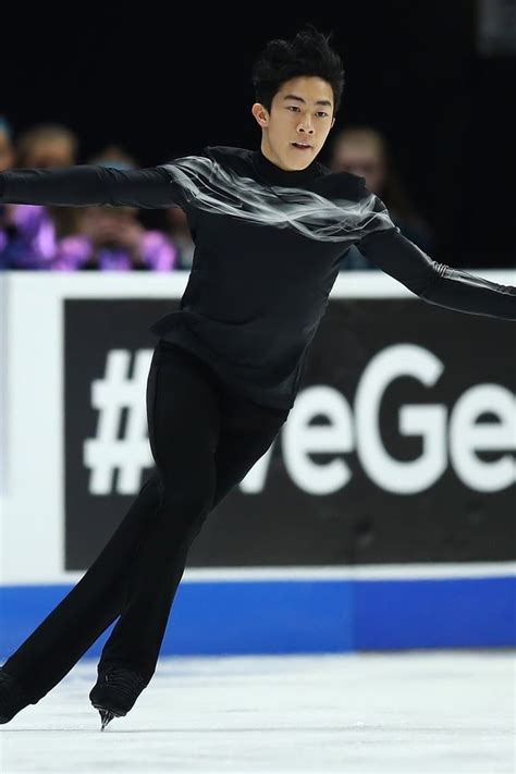 A Male Figure Skating On An Ice Rink
