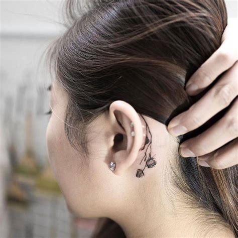 Dry Flower Tattoo Behind The Left Ear
