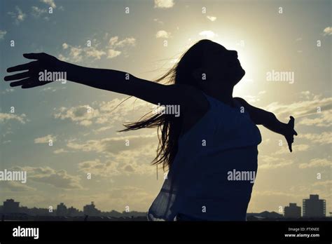 Silhouette Of A Girl Standing With Outstretched Arms Stock Photo Alamy