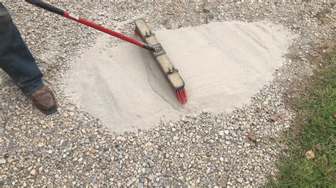 Brushing Cheap Concrete Onto A Gravel Driveway Adding Strength And