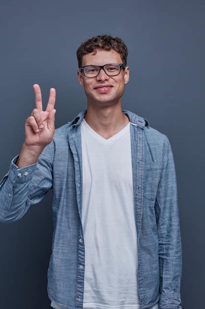 Premium Photo Young Man Showing Victory Sign