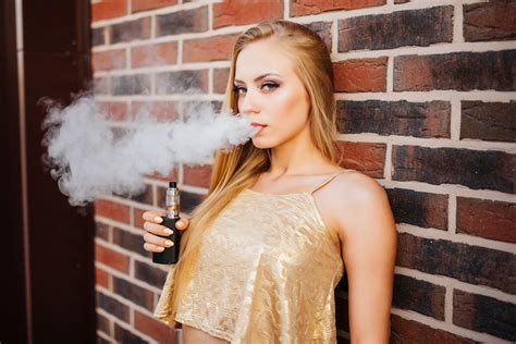 Vaping Young Beautiful Girl Smoking Vaping E Cigarette With Smoke