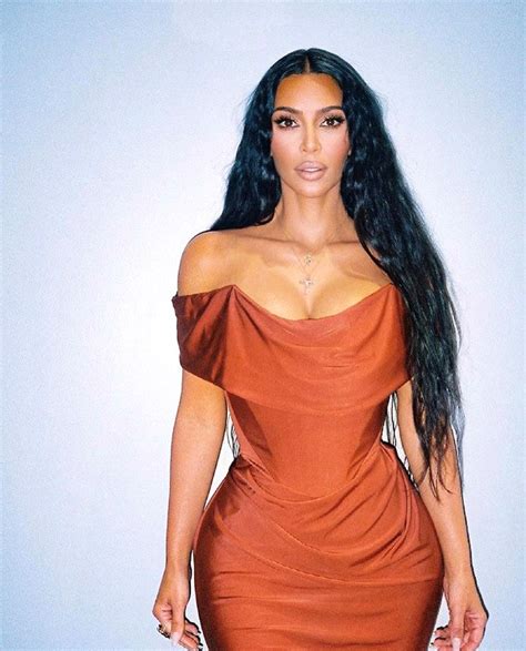 kim kardashian serves looks in sexy pictures in an off shoulder satin bodycon gown by vivienne