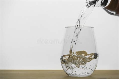 Motion Blur Of Pouring Pure Drinking Water Flow Into The Glass On