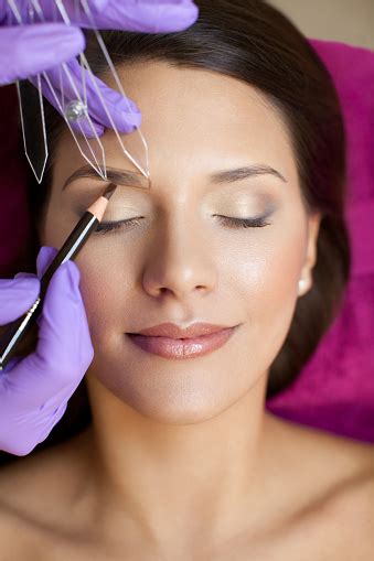 Beautiful Woman In Beauty Slon On Eyebrow Makeup Treatment Stock Photo