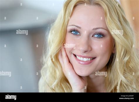 Portrait Of Smiling Blond Woman With Curly Hair Stock Photo Alamy