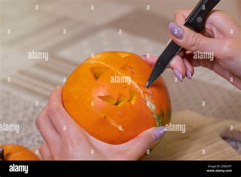 The Process Of Making A Halloween Pumpkin Cutting Out The Mouth Horror Theme And Hallowe En