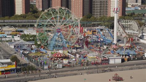 Hop on public transit if driving's not your speed; 4K stock footage aerial video flyby Luna Park Ferris wheel ...