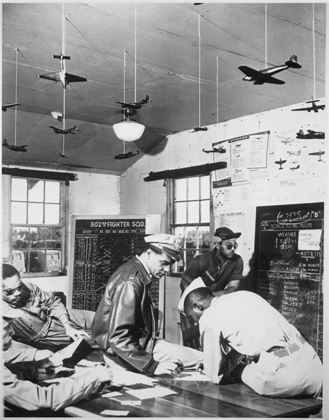 Tuskegee Airmen Pilots Study Their Briefing Before Flying A Practice