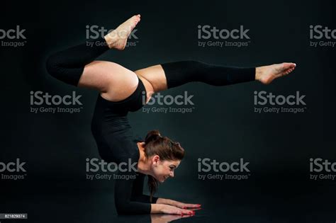 Flexible Gymnast Doing Exercise On Black Background Hands Standing