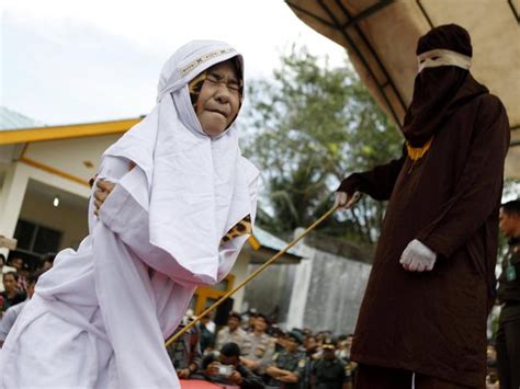 man publicly caned in indonesia for having sex outside of marriage faints during punishment