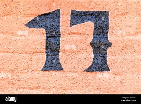House Number Seventeen 17 Painted In Black Paint On An Orange
