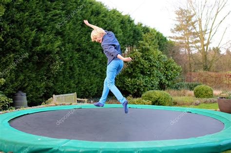 Happy Boy Jumping On Trampoline — Stock Photo © Cromary 113827460