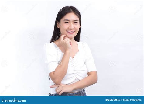 portrait asian beautiful girl in white shirt touches her face and smiles on white background