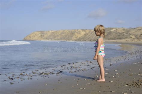Una Niña Está Jugando En La Playa Imagen De Archivo