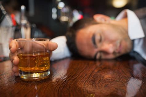 Premium Photo Drunk Businessman With Whiskey In His Hand Lying On A Counter