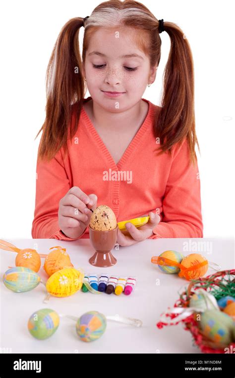 Beautiful Girl With Pigtails Painting Easter Eggs Stock Photo Alamy