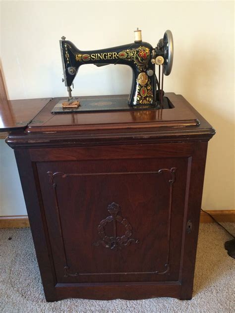 this is one of my singer 66 red eyes in a parlor cabinet i just love these antique sewing