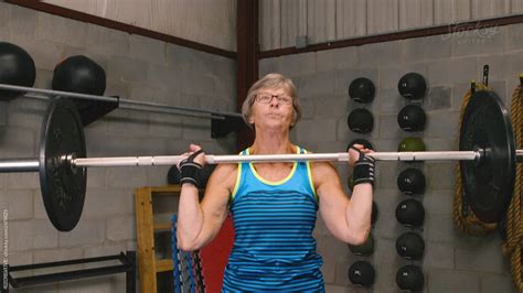 Senior Woman Lifting At Gym By Stocksy Contributor RZCREATIVE Stocksy