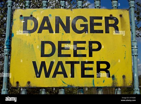 Danger Deep Water A Warning Sign With Black Text On A Yellow