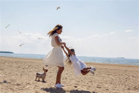 Mother And Daughter Dressed In White Fool Around In Dresses Photograph
