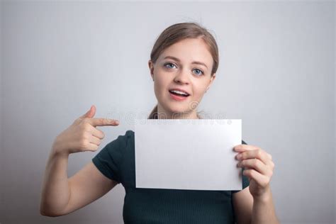 Smiling Young Caucasian Woman Girl Holding Blank White Paper Sheet With Copy Space Stock Image