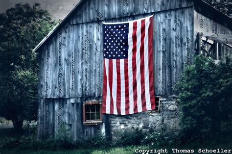American Flag Boldly Displayed On The Gable End Of A Rustic Woodbury