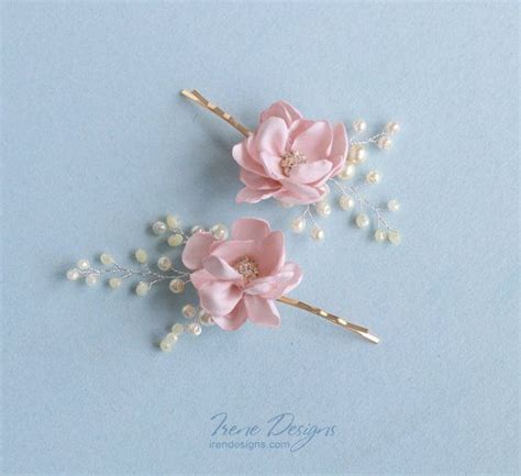 Two Hair Pins With Flowers And Pearls On Them