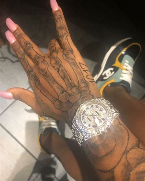 'little guitarist' tattoo on his left arm. Hand In Hand Tattoos Pinky in 2020 | Hand tattoos, Skeleton hand tattoo, Hand tattoos for women