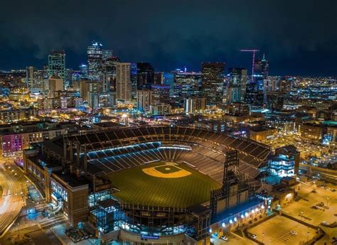Coors Field In The Evening With The Mile High Skyline Home To The Mlb