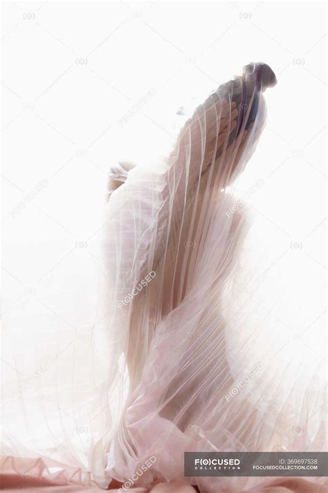 Anonymous Naked Model Covered With Transparent Pleated Fabric Of