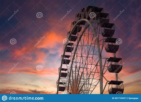 Illuminated Ferris Wheel At Sunset Colorful Sky And Ferris Wheel