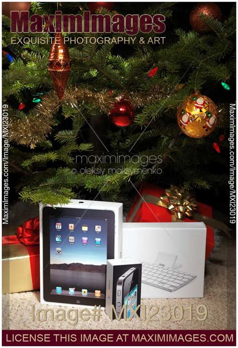Photo Of Apple Ipad And Iphone Amongst Christmas Presents Stock Image