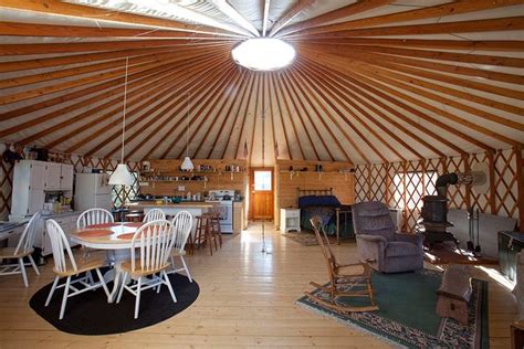 The Inside Of A Yurt With Chairs And Tables