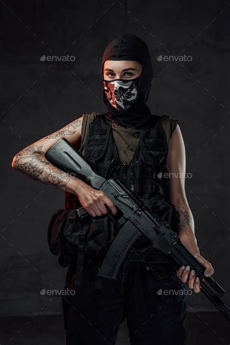 Female Soldier Poses In Dark Background Holding Assault Rifle Stock