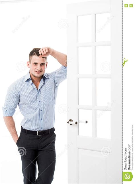 Portrait Casual Young Man Leaning Against The Frame Of An Open Door On